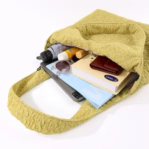 Internal view of a large capacity yellow bubble textured tote bag with items