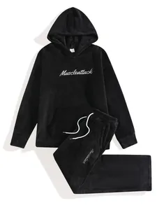 High-detail view of men's black fleece loungewear set with Muscleattack embroidery.
