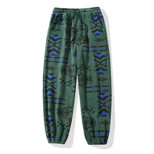 Green thermal fleece joggers featuring tribal geometric patterns and drawstring waist