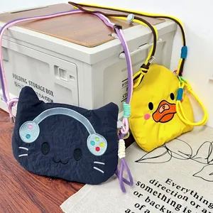 Cute cartoon cat and duck crossbody bags with colorful rope straps in a lifestyle setting.