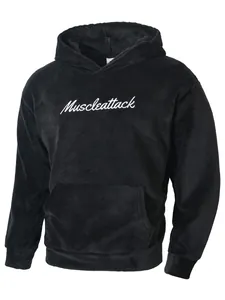 Close-up detail of soft black fuzzy fleece men's hoodie with white Muscleattack embroidery