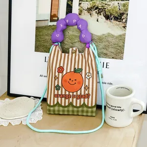 Close-up detailed view of cartoon orange pattern mini crossbody bag for women