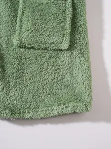 Close-up of sage green fuzzy plush hoodie showing soft texture and pocket detail