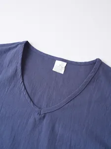 Close-up of V-neckline and fabric texture of a navy blue linen casual shirt