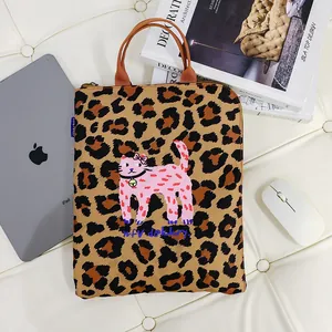 Leopard print tote bag featuring a pink graffiti cat illustration and top handles