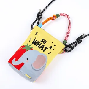 Detail of yellow canvas bucket bag with cartoon elephant print and colorful rope handle