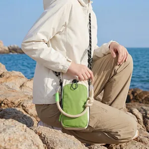 Outdoor lifestyle view of colorful Japanese style crossbody phone bag with rope strap