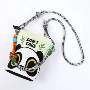 Detailed shot of a cute panda print canvas crossbody bag with braided cord strap