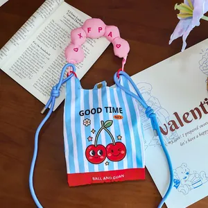 Close-up view of a cute blue striped mini crossbody bag featuring a charming cartoon cherry print