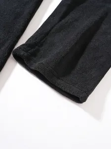 Close-up of soft black fleece fabric detail on sleeve or pant cuff
