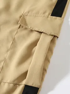 Close-up detail showing the side pocket and black stripe of khaki men's cargo pants
