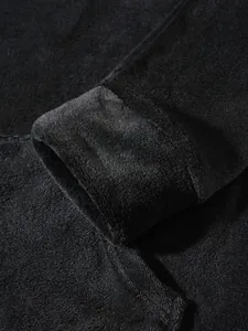 Close-up of black soft fleece fabric texture on a men's loungewear sleeve cuff