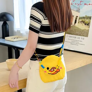 Detailed view of a cute yellow cartoon duck mini crossbody bag with vibrant colorful straps