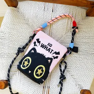 Detail view of pink canvas bucket bag with cute cartoon cat print and SO WHAT text