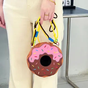 Detail of a cute donut-shaped crossbody bag with pink frosting and colorful sprinkles