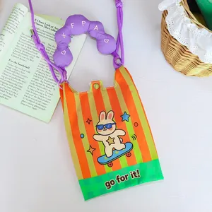 Detail view of mini crossbody phone bag with cartoon rabbit and padded purple handle