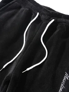 Detail view of men's warm fuzzy lounge pants with white drawstring and embroidery