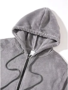 Detail view of grey fleece zip-up hoodie featuring hood and drawstring texture
