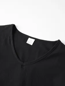 Close-up view of the V-neckline and internal care label on a black linen blend men's top.