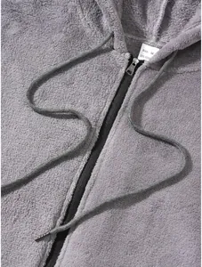 Detail of soft grey fleece hoodie with black zipper and drawstring cords