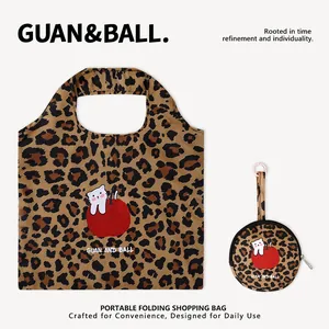 Leopard print folding shopping bag with cute cartoon cat and apple graphic details
