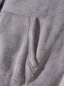 Close-up of soft gray fleece fabric and pocket detail of the hooded sweatshirt set.