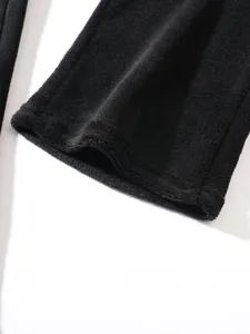 Detailed view of the soft black fleece fabric texture on men's thermal loungewear hem