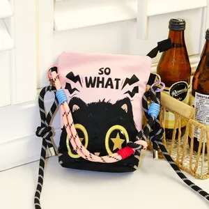Detail view of pink canvas bucket bag featuring a cute black cat print and thick rope strap