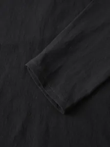 Macro view showing the breathable linen fabric texture and stitching of the black sleeve cuff