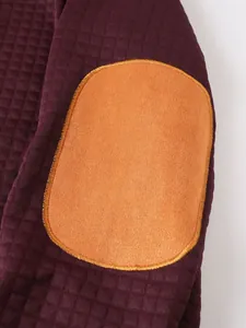 Vista de detalle de sudadera acolchada burdeos con parche naranja en el codo