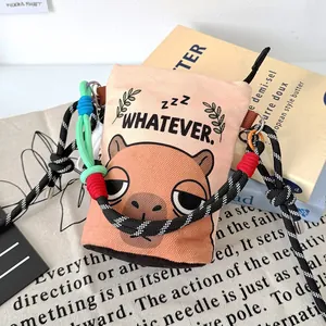 Detail view of the cute capybara printed canvas bucket bag with colorful braided strap.