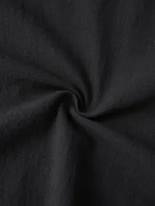Close-up macro detail of black breathable linen fabric texture for men's casual top