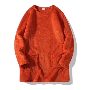Detailed macro view of orange plush long-sleeved sweatshirt with front pockets texture