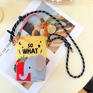 Detail view of yellow bucket bag with cute cartoon elephant and strawberry print