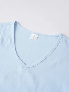 Close-up view showing the V-neckline and breathable linen texture of the light blue casual top
