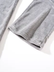 Close-up of soft grey plush fleece trouser leg showing the thick warm fabric texture