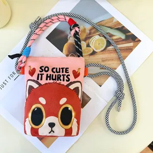 Detail view of pink cartoon crossbody bag with red panda print and rope strap. Stylish design.