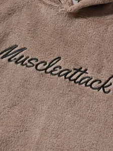 Detail of black Muscleattack script embroidery on soft fuzzy brown men's thermal loungewear