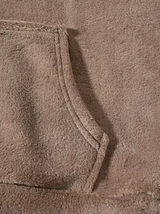 Close-up of soft brown fleece fabric and durable pocket stitching on men's lounge set.