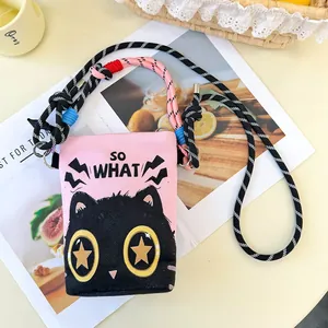Detailed view of a pink cartoon cat crossbody bag with SO WHAT text and thick rope strap.