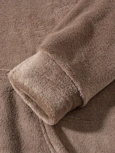 Detailed close-up showing the soft plush fleece sleeve cuff of a warm brown lounge set.