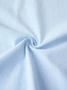 Detailed macro view of the light blue breathable linen fabric texture for casual tops