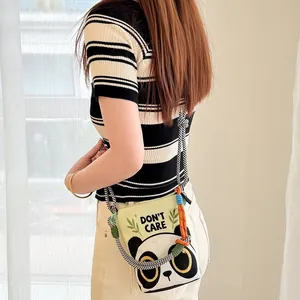 Model wearing a casual panda print crossbody bag with multi-color braided rope strap.