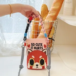 Detail shot of a cute cartoon red panda print on a pink stylish crossbody bucket bag