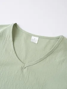 Detailed view of the V-neckline and washing label for a men's linen blend casual top