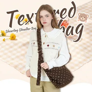 Brown plush shoulder bag with white flower pattern and adjustable wide strap for women.
