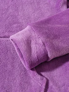 Macro detail showing the soft texture of a purple fleece cuff on warm winter pajamas