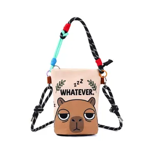 Cartoon capybara print crossbody bucket bag with colorful rope straps and 'Whatever' text.