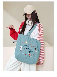 Casual blue tote bag with cute cat embroidery and functional drawstring closure detail