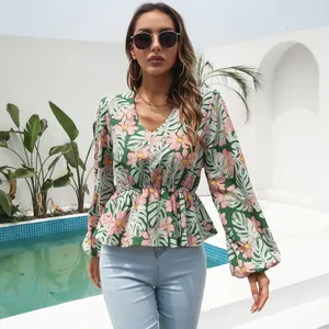 Close-up detail view of elegant floral print V-neck chiffon blouse with lantern sleeves